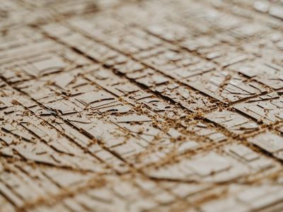 Close-up of hands gripping a wooden floor during a plank.